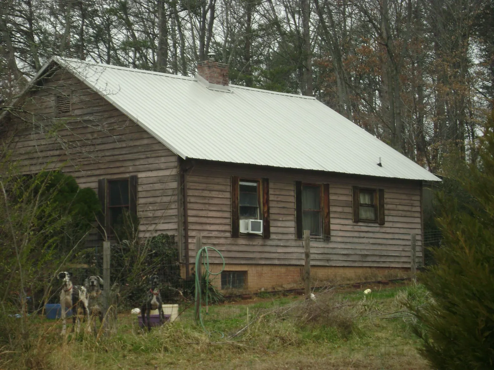 White metal roof on an old wood sided farmhouse, from a Metal Roof Installation job in Whitwell