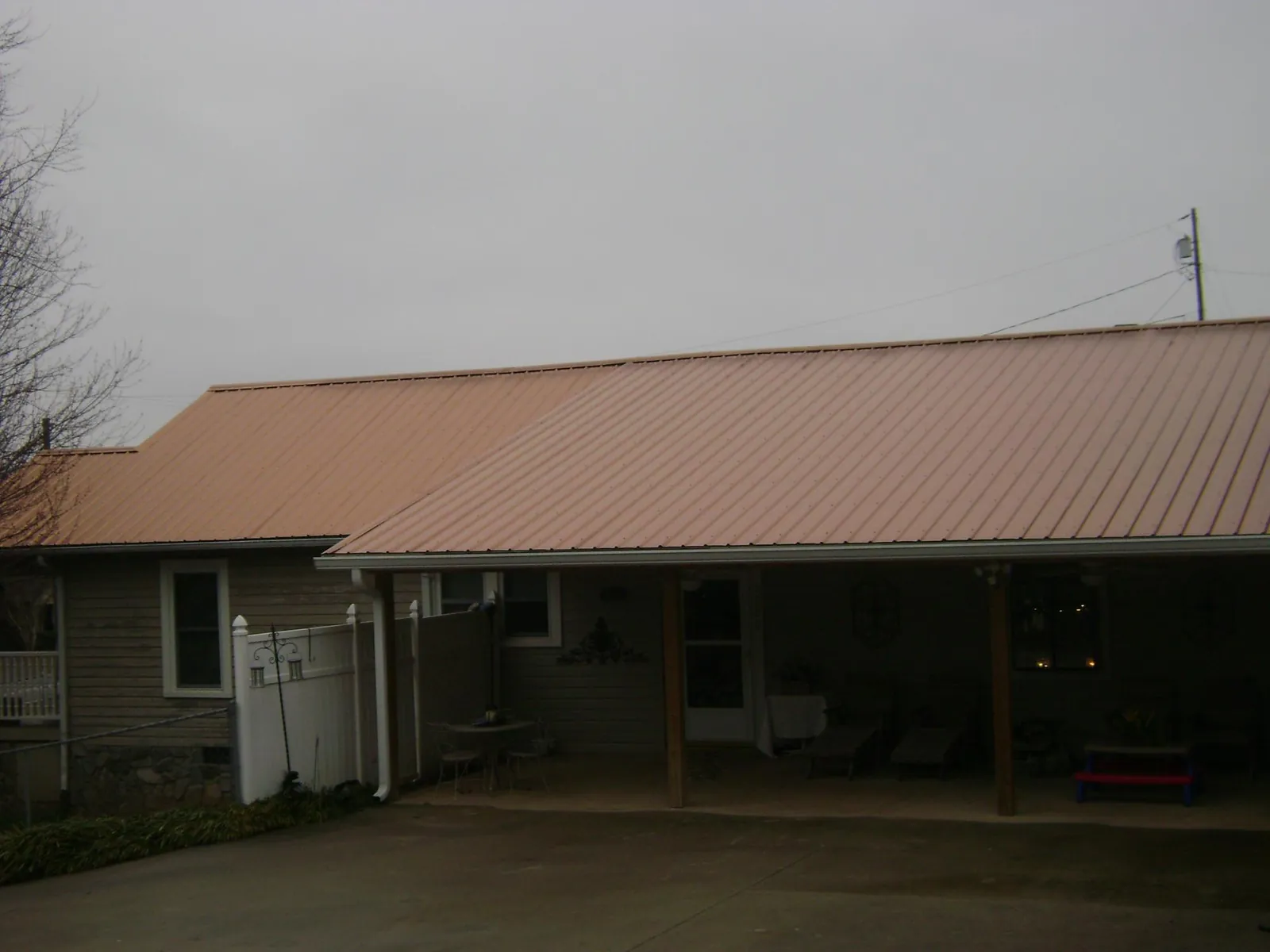 Copper toned metal roof over a wide covered patio in Whitwell